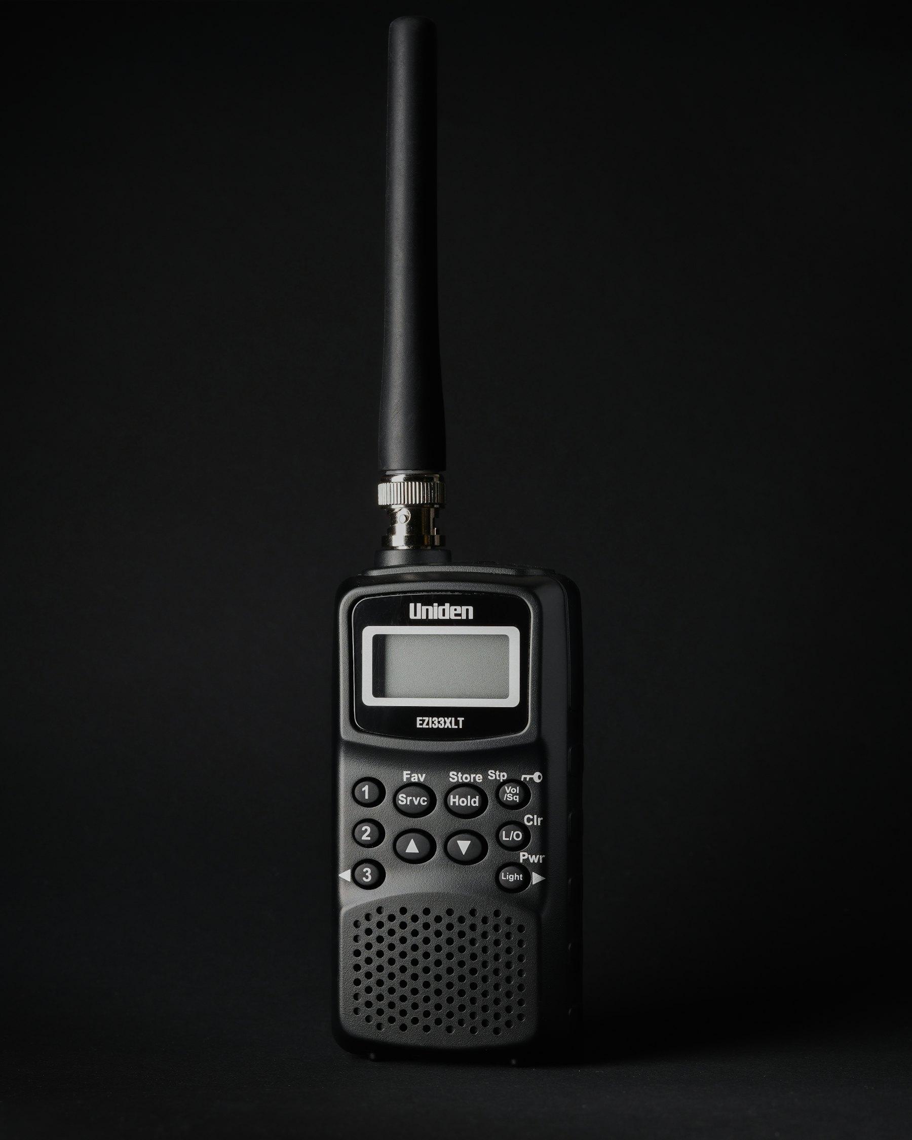 Handheld two-way radio on a dark background